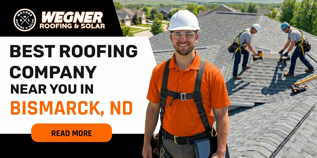 Smiling roofer on roof with crew, showcasing best roofing company near me in Bismarck, ND